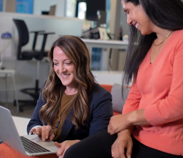 ai-coaching-human-centered-guidance Person guiding another through AI strategy, leading to a positive breakthrough moment