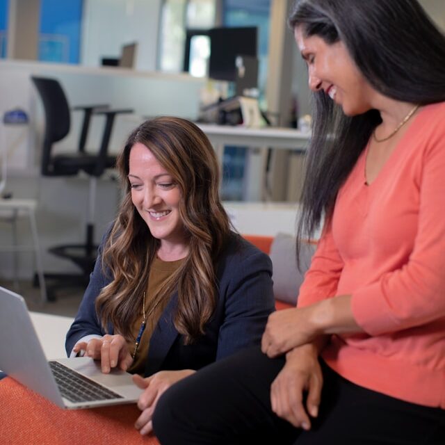 Person guiding another through AI strategy, leading to a positive breakthrough moment